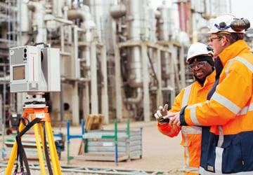 two people in orange high-vis on a construction site 