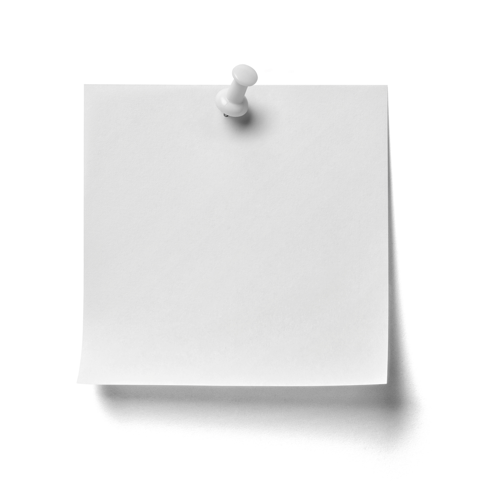 close up of a note paper with a red push pin on white background