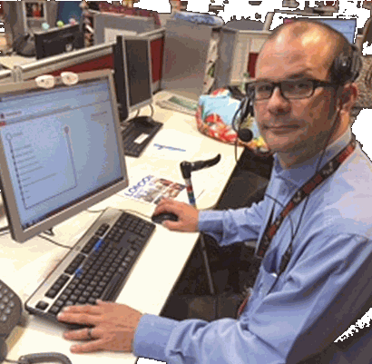 Employee at their desk using the process library on screen